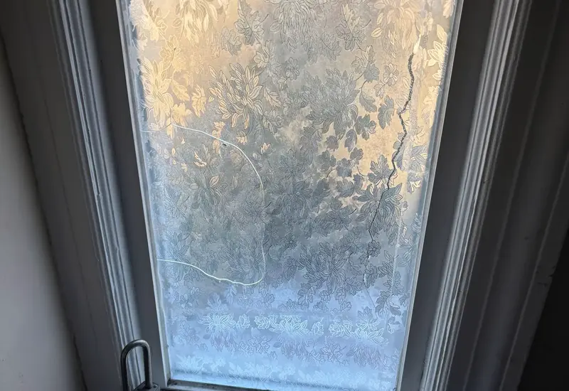 A fogged and cracked glass unit in a window