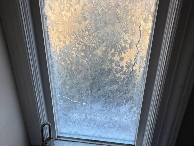 A fogged and cracked glass unit in a window