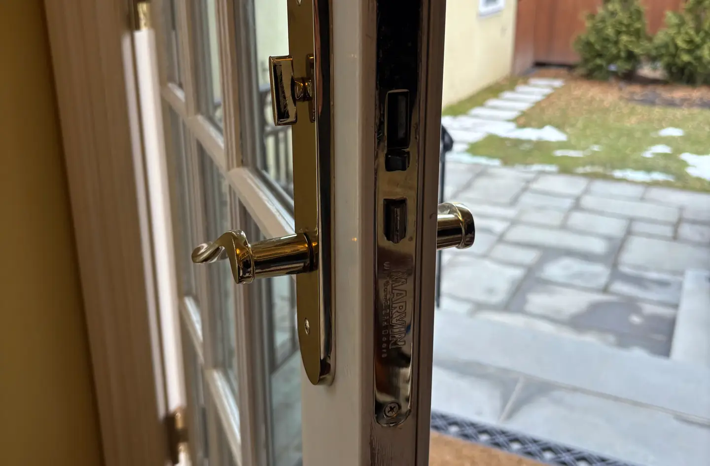 A brass handle and multipoint lock on a French door