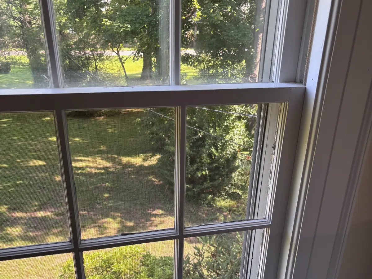 An old wood double hung window with divided panes