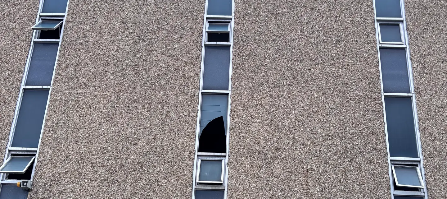 A commercial building wall with tall narrow strip windows