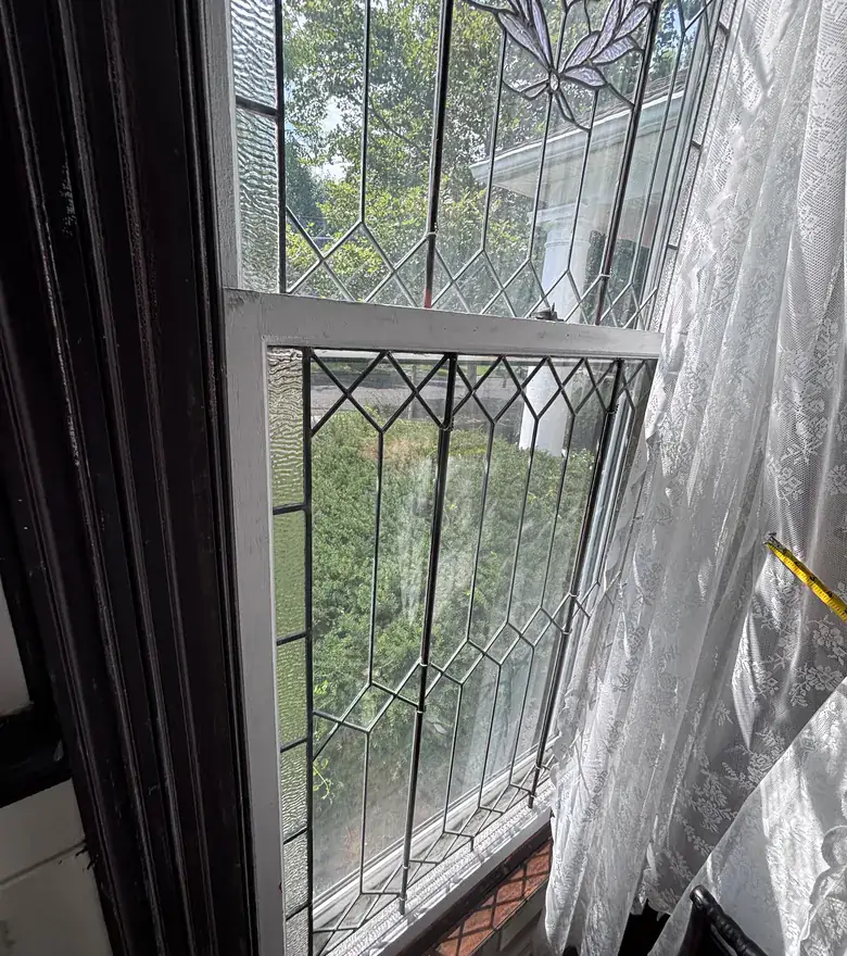 A leaded glass double hung window sash
