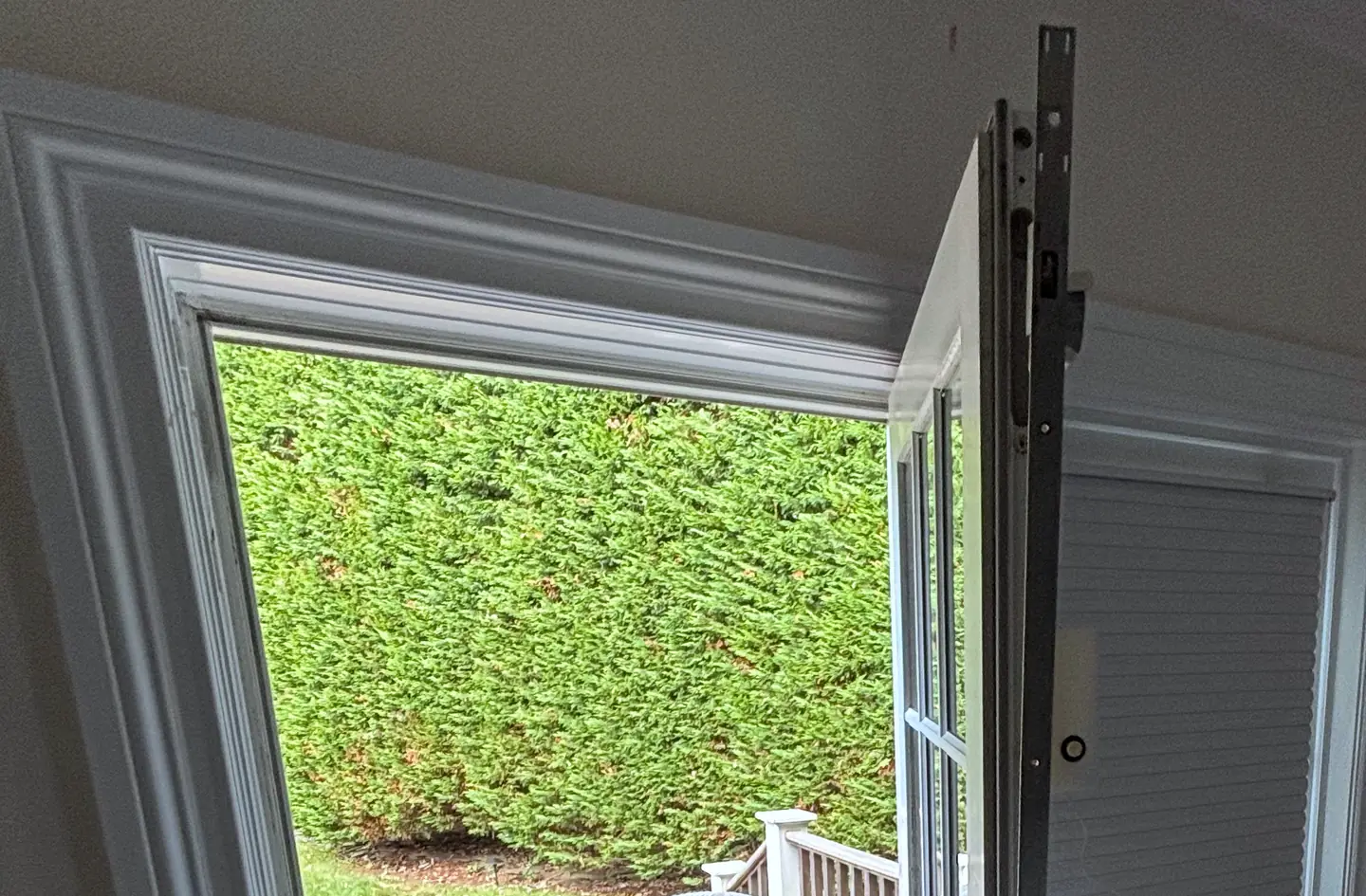 A French door standing open to a deck