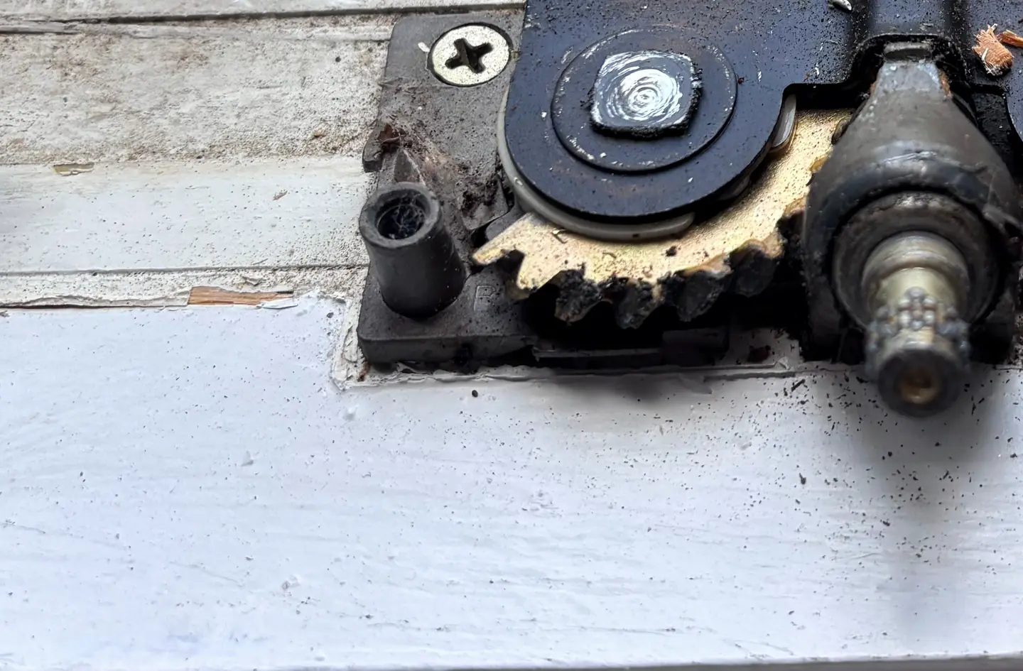 A casement window operator gearbox opened up on the sill