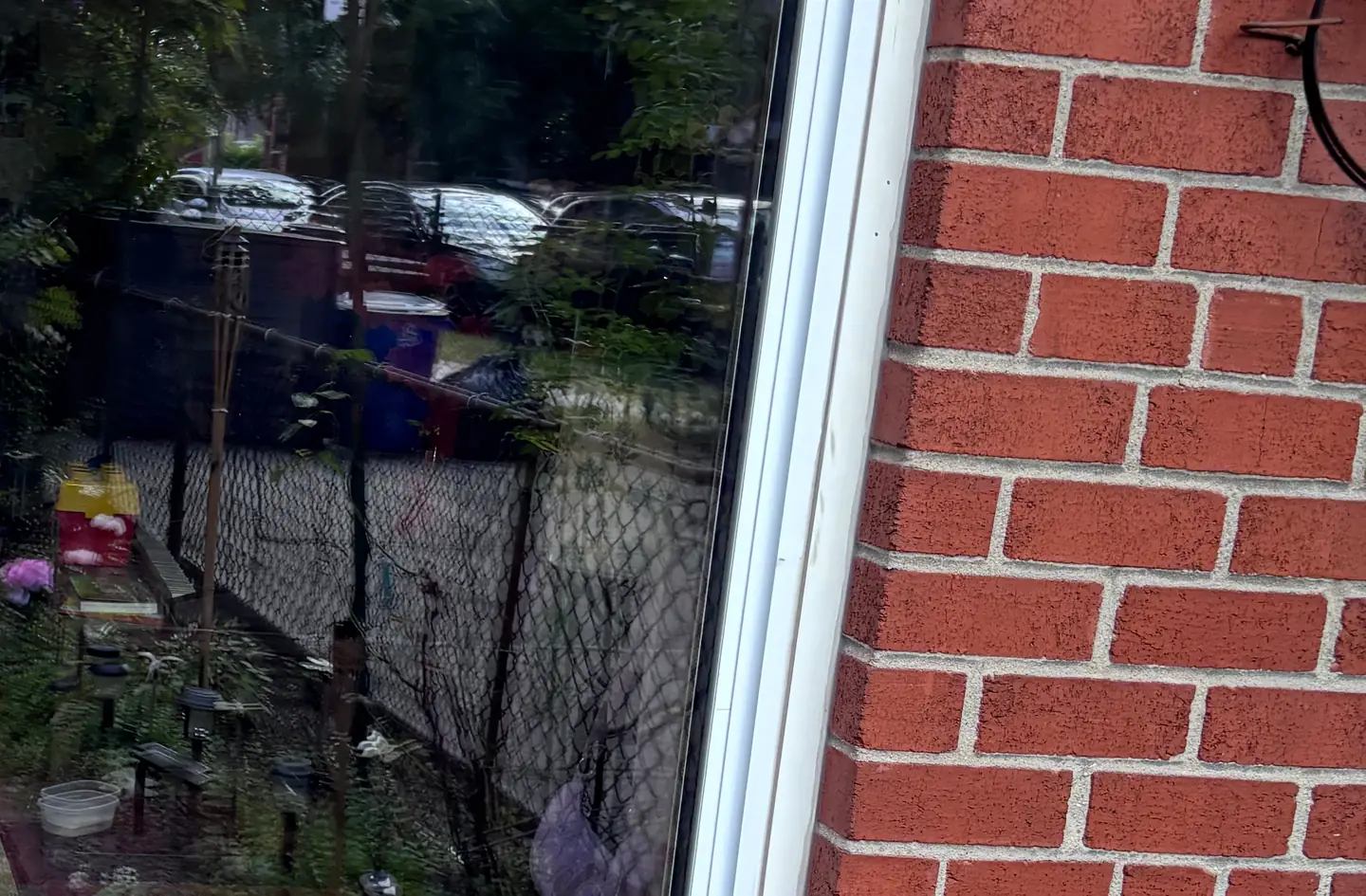 The lower part of a sliding patio door in a brick wall