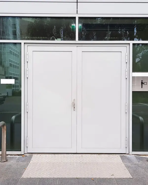 White double entrance doors in a glass building front