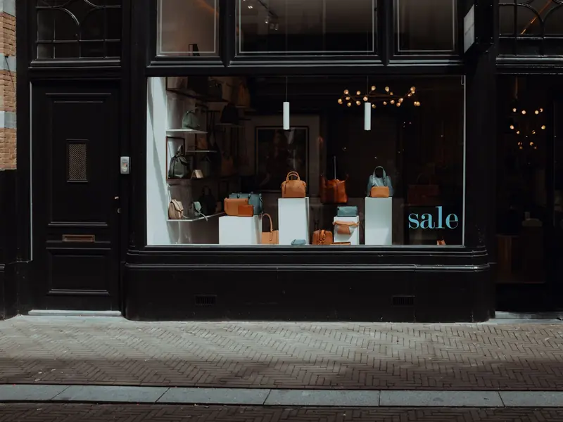 A black storefront with its entry door beside the display window