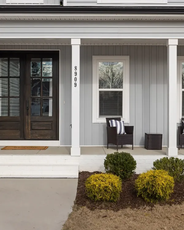 A new double entry door on the front porch of a house