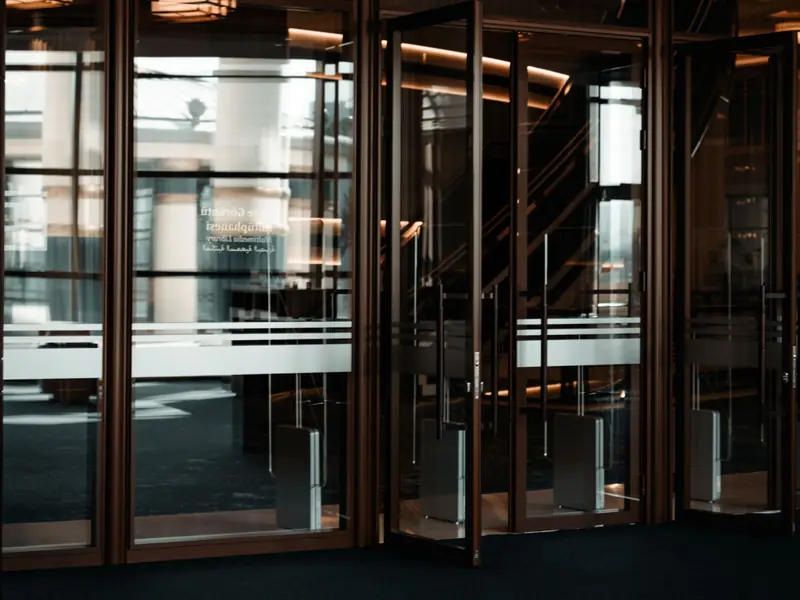 Open glass entrance doors of a commercial building lobby