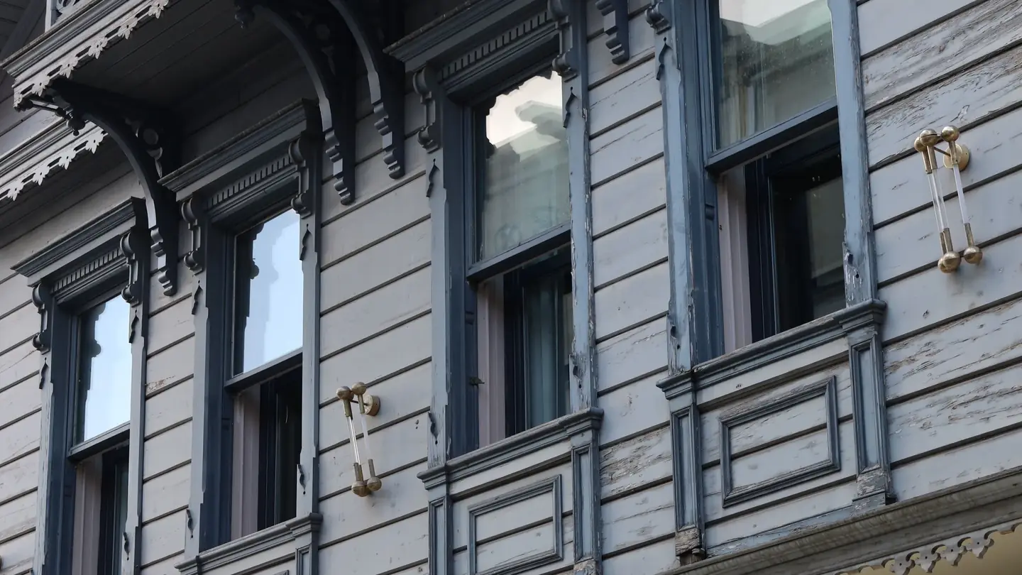 A Victorian house with ornate window hoods