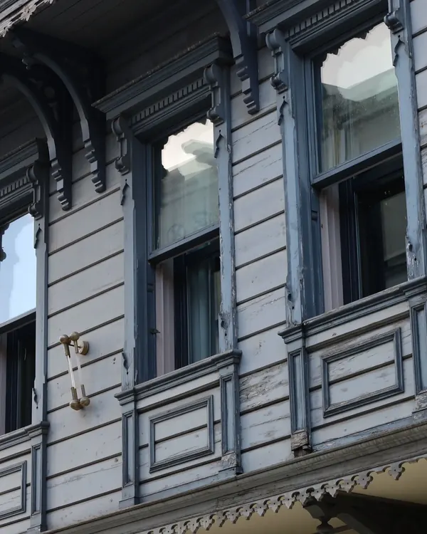A Victorian house with ornate window hoods