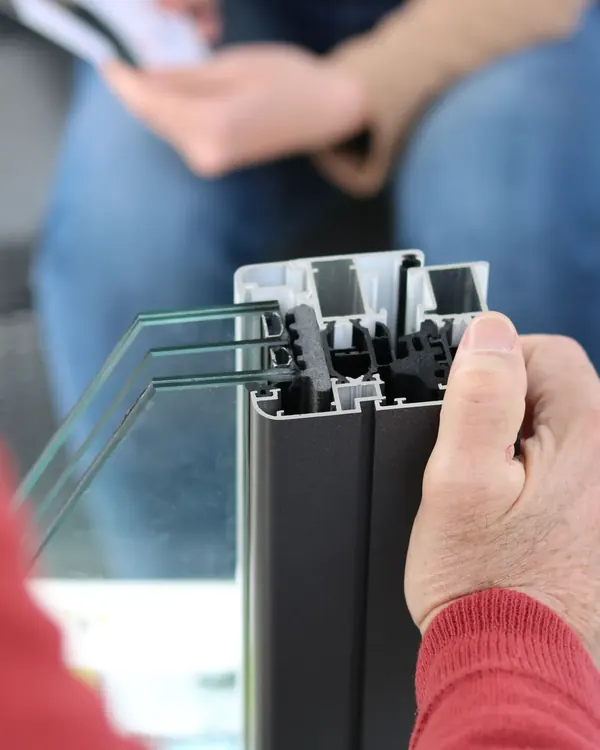 The edge of an insulated glass unit and its frame held in a hand