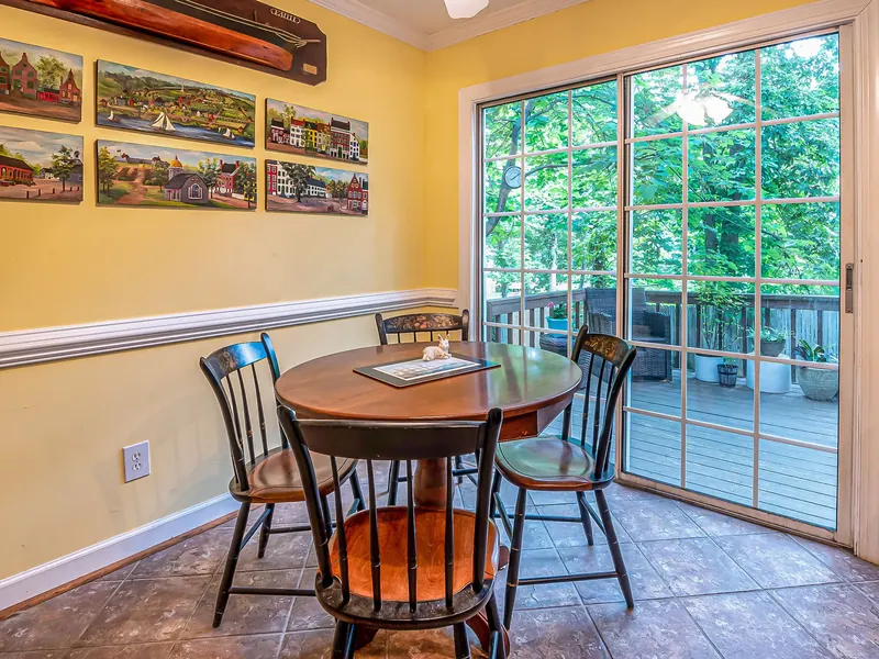 A sliding glass patio door from a dining room onto a deck