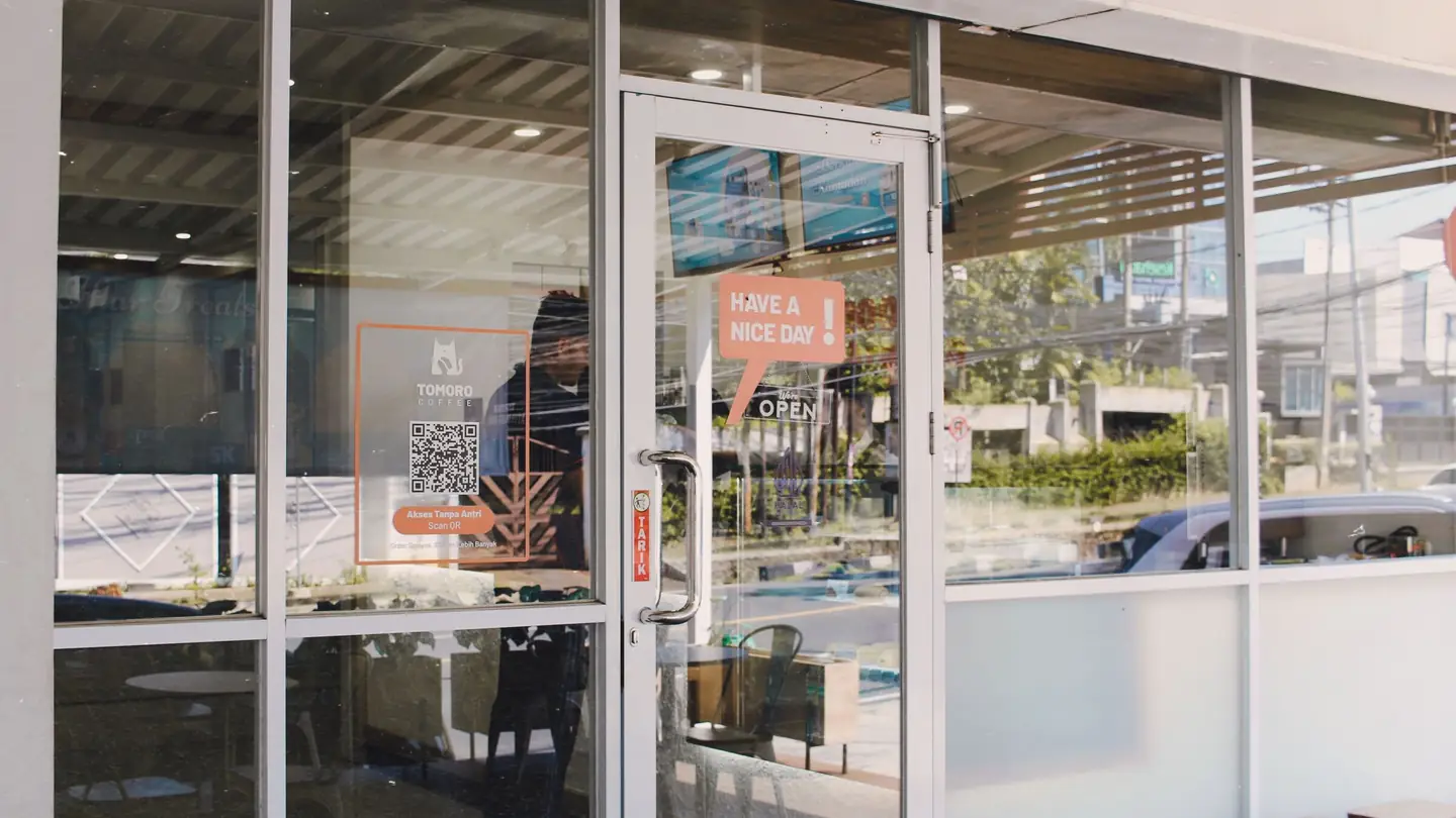 A glass storefront entrance door in an aluminum frame