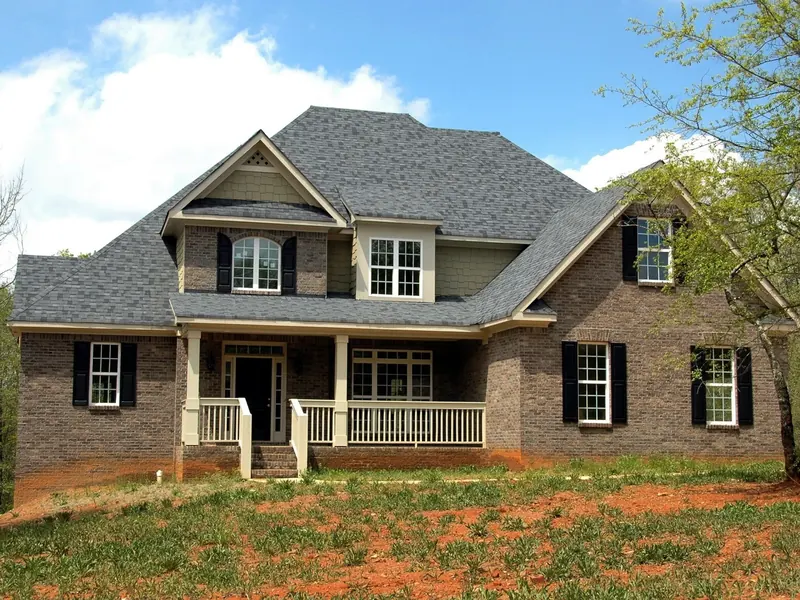 A brick and siding house with many windows