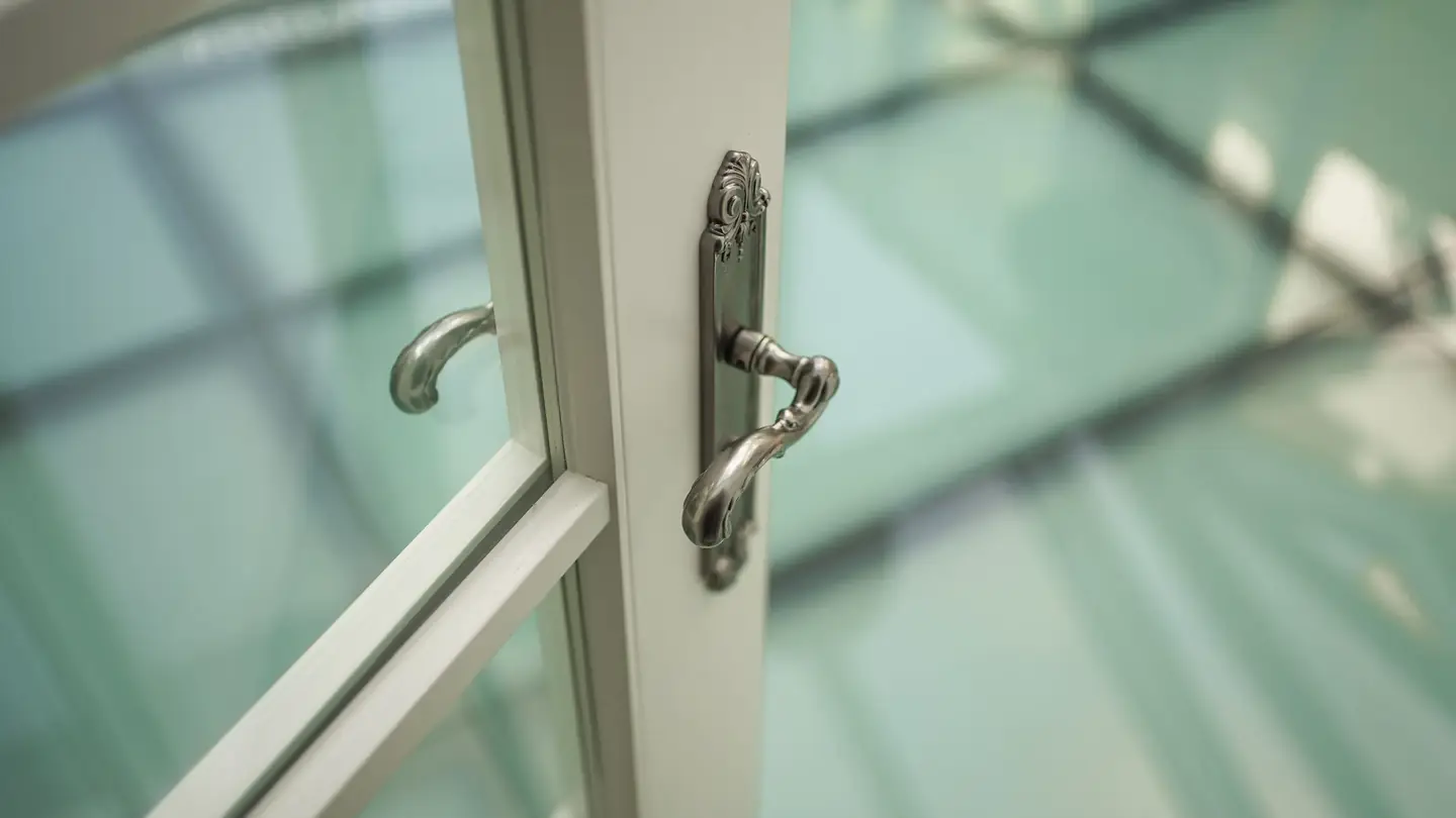 The handle of an open casement window