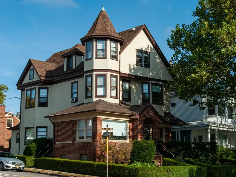 A large old house with many kinds of windows