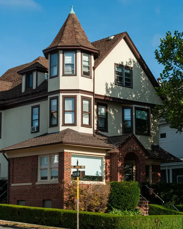 A large old house with many kinds of windows