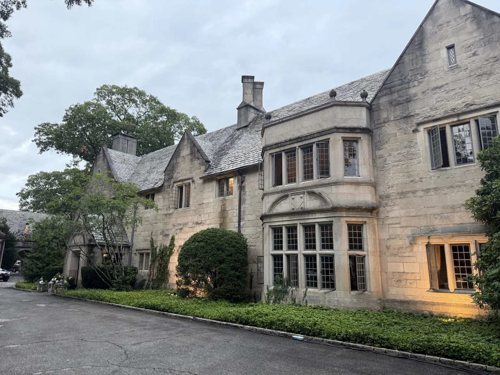 Rynwood, a Tudor style stone mansion with tall leaded windows, in Old Brookville, NY